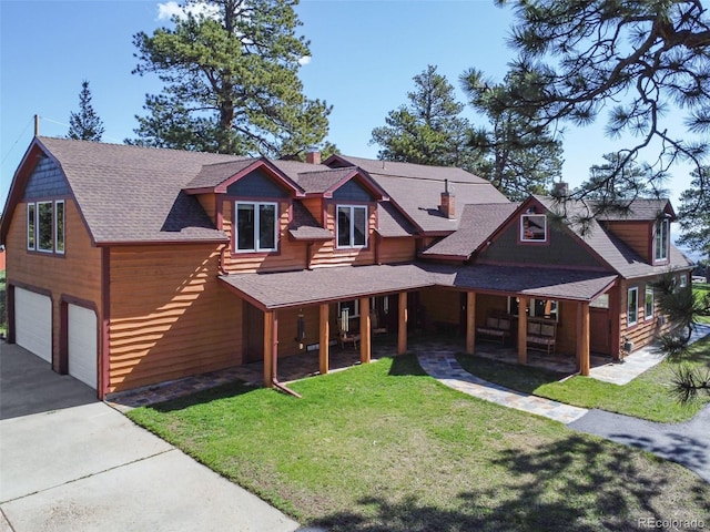 view of front facade with a garage, a shingled roof, a front lawn, and aphalt driveway