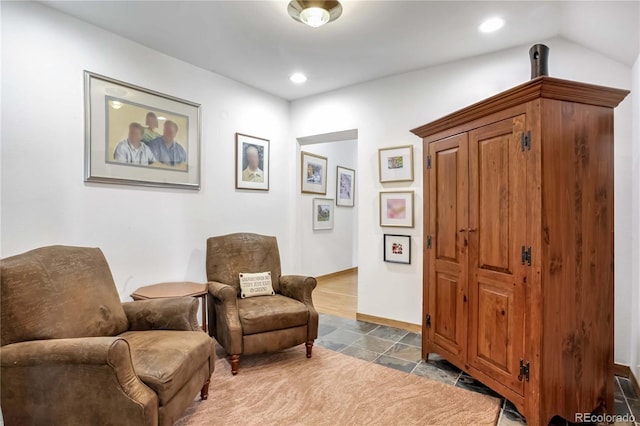 living area featuring stone tile flooring, recessed lighting, and baseboards