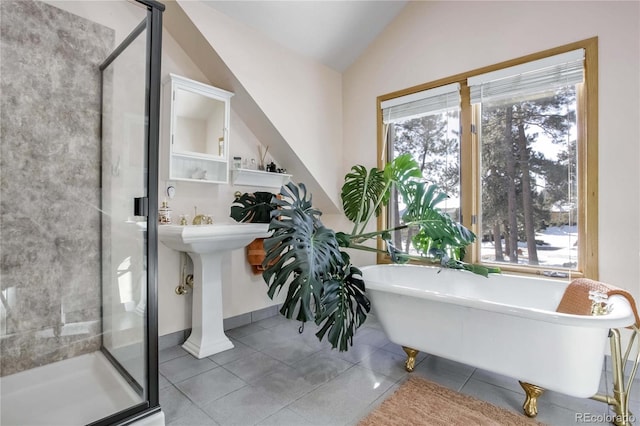 full bath with tile patterned floors, baseboards, a freestanding tub, a shower stall, and lofted ceiling