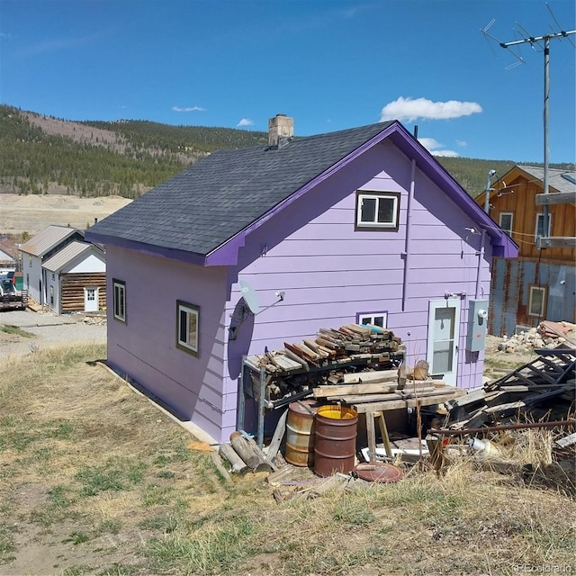 33 S Oak St, Alma, CO 80420 - back of house with a shingled roof and a chimney