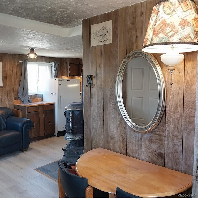 33 S Oak St, Alma, CO 80420 - dining area with wood walls, light wood finished floors, and a textured ceiling