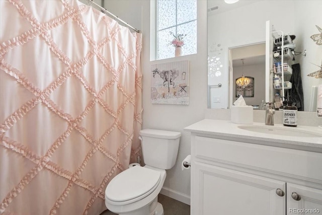 bathroom with toilet, a shower with shower curtain, and vanity