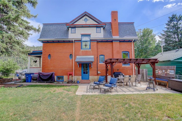 back of property featuring a lawn, a pergola, and a patio