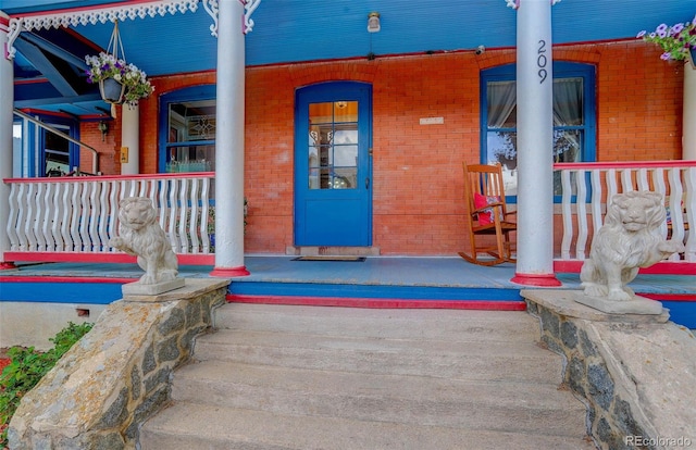 view of exterior entry featuring a porch