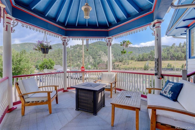 sunroom / solarium with a mountain view and lofted ceiling