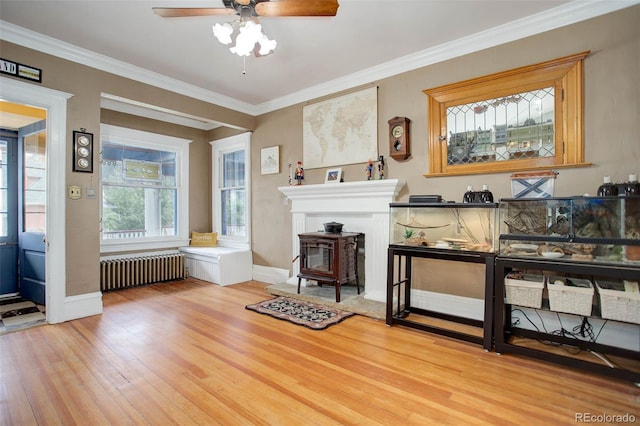 misc room with hardwood / wood-style flooring, ceiling fan, and crown molding