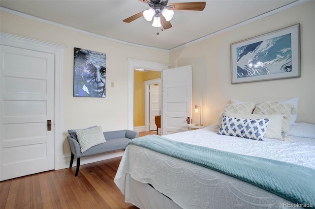 bedroom featuring hardwood / wood-style floors, ceiling fan, and ornamental molding