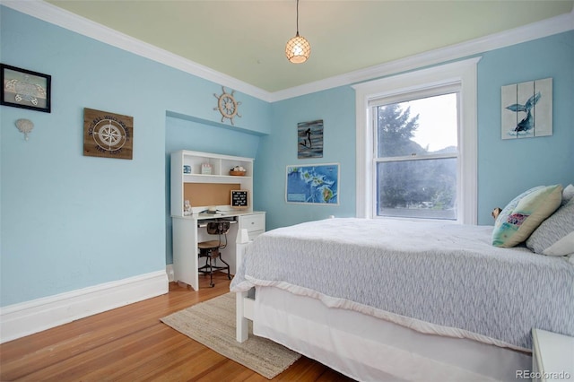 bedroom featuring crown molding and hardwood / wood-style flooring