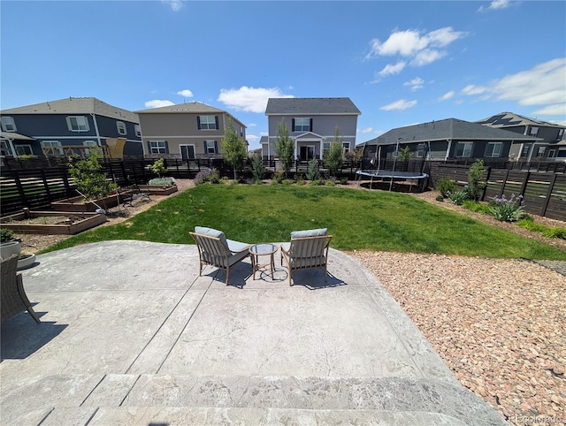 9 N Waterloo St, Aurora, CO 80018 - view of patio / terrace with a trampoline, a vegetable garden, and a residential view