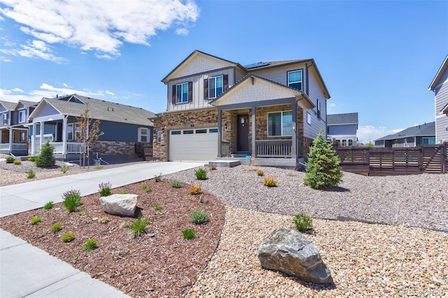 9 N Waterloo St, Aurora, CO 80018 - craftsman-style house with a porch, driveway, roof mounted solar panels, stone siding, and a garage