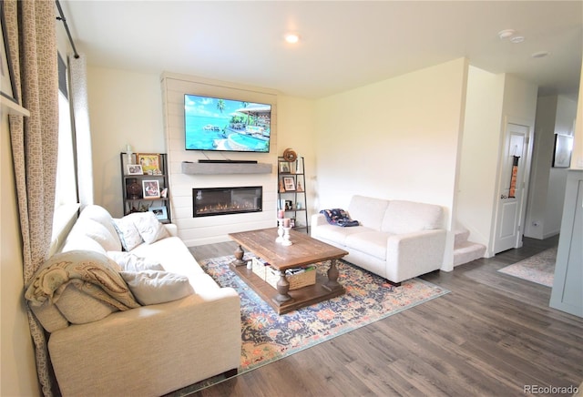 9 N Waterloo St, Aurora, CO 80018 - living room with dark wood-style flooring, a glass covered fireplace, and recessed lighting