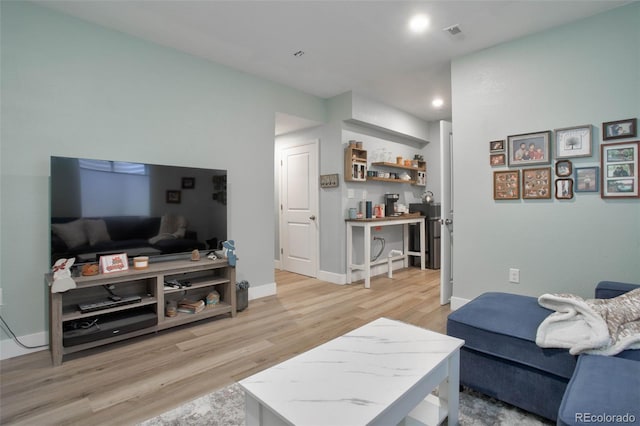 9 N Waterloo St, Aurora, CO 80018 - living area featuring light wood-type flooring, baseboards, and recessed lighting