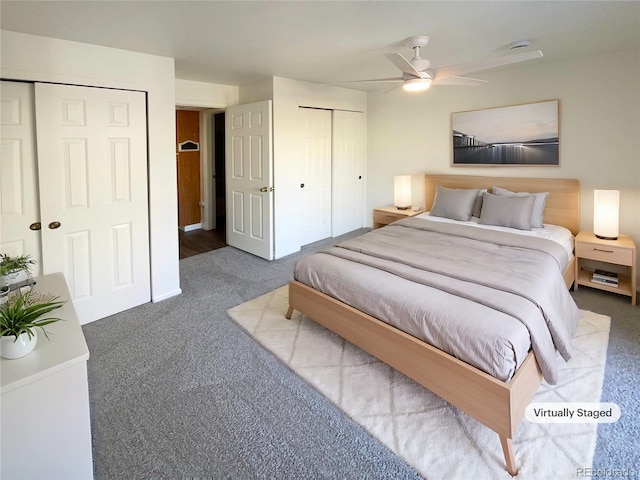 bedroom featuring carpet flooring, ceiling fan, and two closets