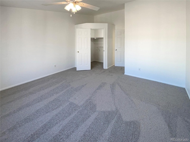 unfurnished bedroom featuring carpet flooring, a walk in closet, ceiling fan, and a closet