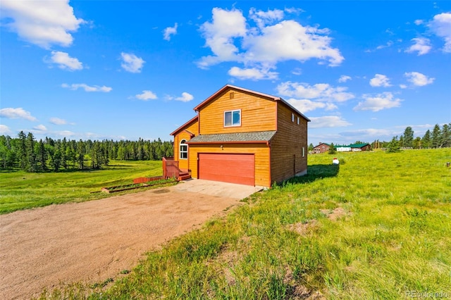 428 Ridge Dr, Divide, CO 80814 - view of home's exterior with concrete driveway, a garage, and a yard