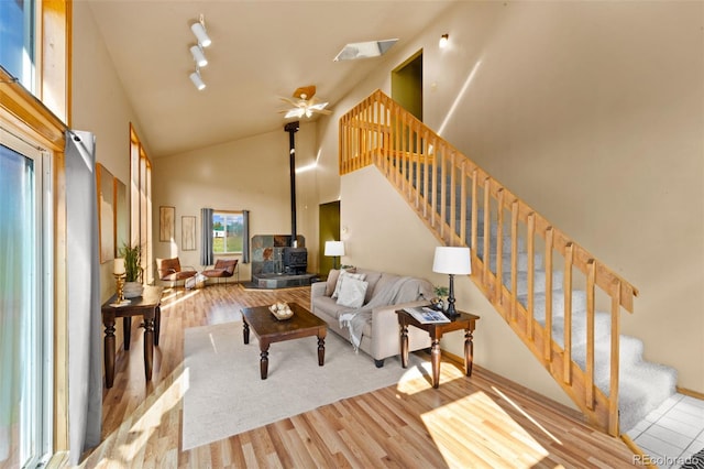 428 Ridge Dr, Divide, CO 80814 - living area with a wood stove, high vaulted ceiling, wood finished floors, stairway, and a ceiling fan
