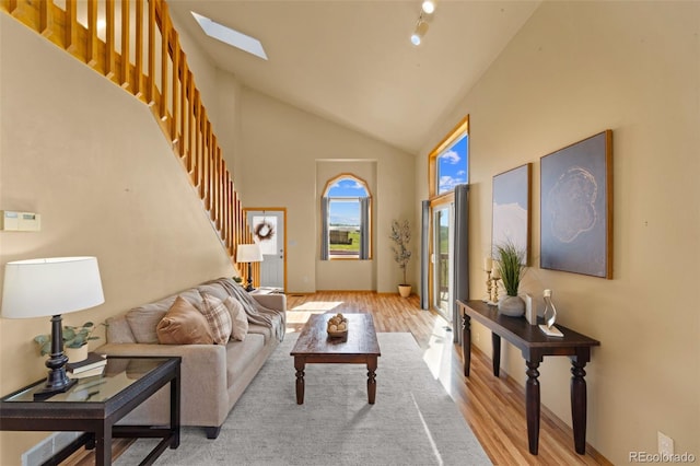 428 Ridge Dr, Divide, CO 80814 - living area featuring stairway, light wood-style floors, high vaulted ceiling, and a skylight