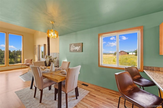 428 Ridge Dr, Divide, CO 80814 - dining room featuring a chandelier, healthy amount of natural light, and light wood-type flooring
