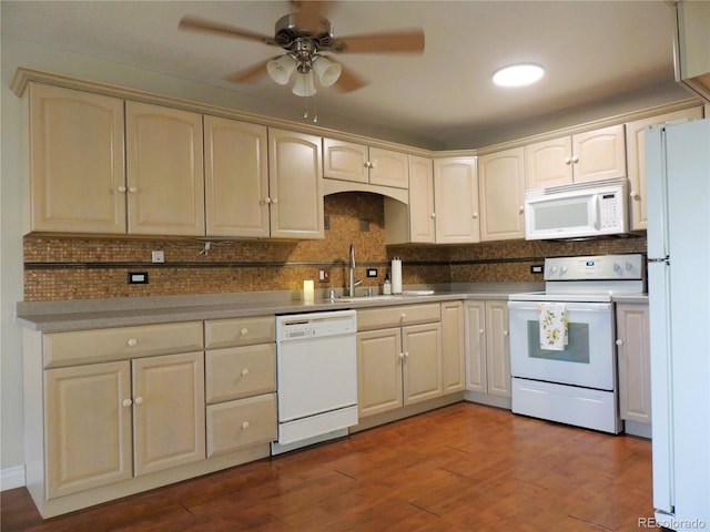 kitchen featuring white appliances, decorative backsplash, dark wood-style floors, ceiling fan, and a sink