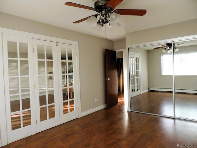 unfurnished bedroom with french doors, a baseboard radiator, ceiling fan, wood finished floors, and baseboards