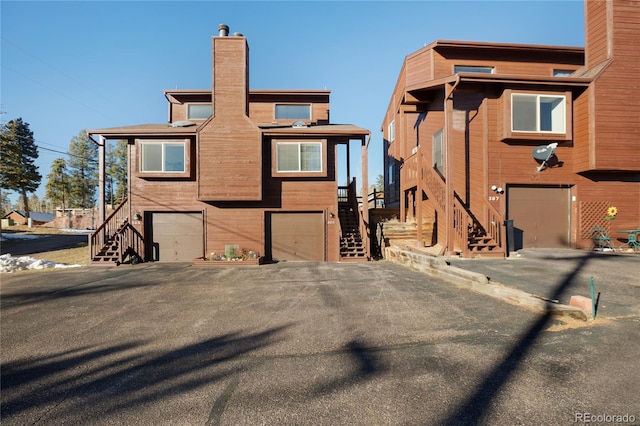 back of house featuring a garage