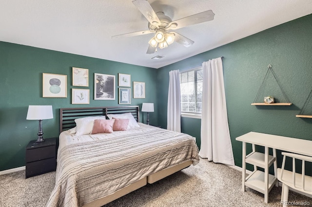 carpeted bedroom featuring visible vents, ceiling fan, a textured ceiling, and baseboards