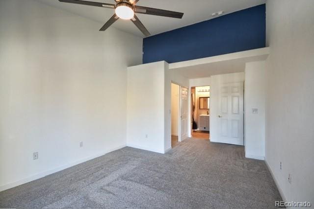 unfurnished bedroom with carpet floors, high vaulted ceiling, a ceiling fan, and baseboards