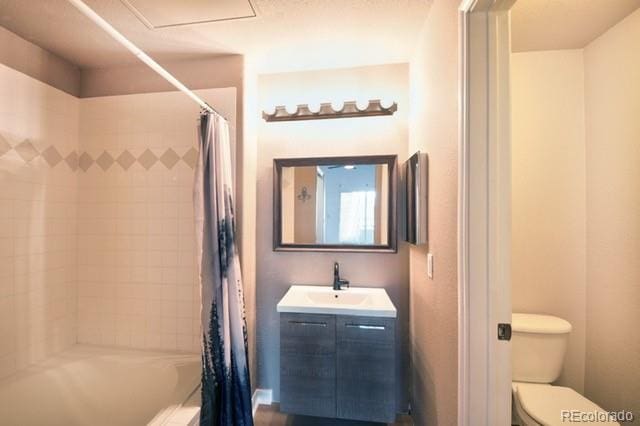 full bathroom featuring shower / tub combo, vanity, and toilet