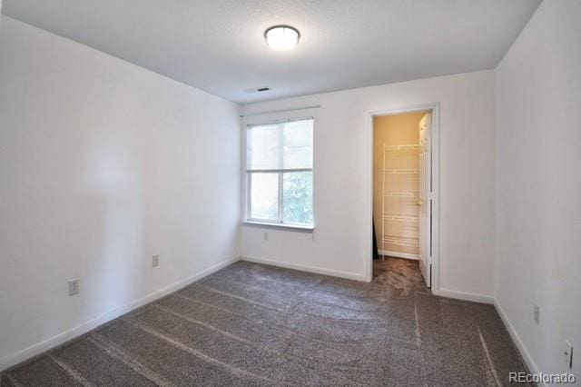 unfurnished bedroom with carpet floors and baseboards