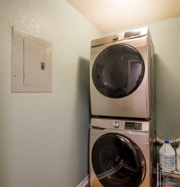 3864 Riviera Grv Unit 204, Colorado Springs, CO 80922 - clothes washing area with electric panel, laundry area, and stacked washing maching and dryer