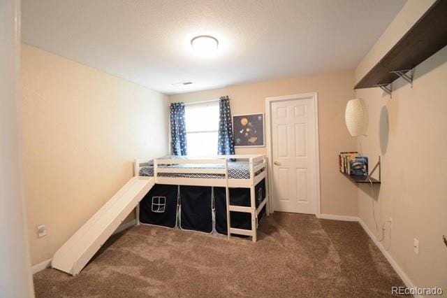 carpeted bedroom featuring baseboards