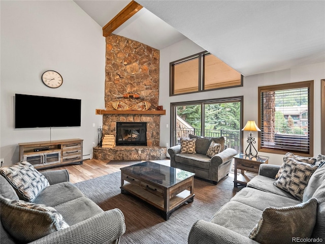 living area featuring high vaulted ceiling, a baseboard heating unit, a fireplace, and wood finished floors