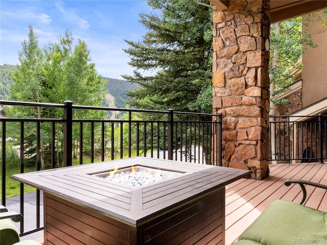 wooden terrace with a fire pit