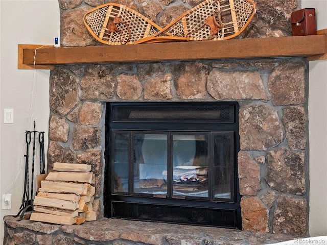 interior details featuring a stone fireplace