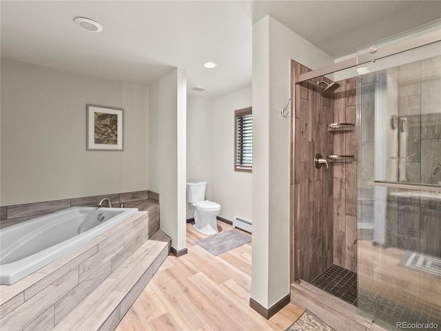 bathroom featuring a baseboard radiator, toilet, a stall shower, wood finished floors, and a bath