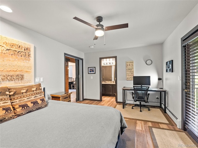 bedroom featuring a baseboard radiator, a ceiling fan, baseboards, light wood-type flooring, and ensuite bath