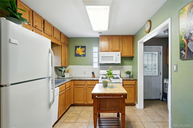 2461 Niagara St, Denver, CO 80207 - kitchen featuring white appliances, tasteful backsplash, light countertops, and light tile patterned flooring
