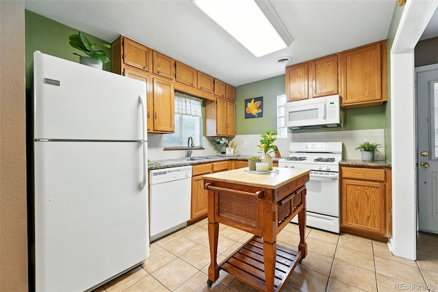 2461 Niagara St, Denver, CO 80207 - kitchen with white appliances, backsplash, light countertops, and light tile patterned floors