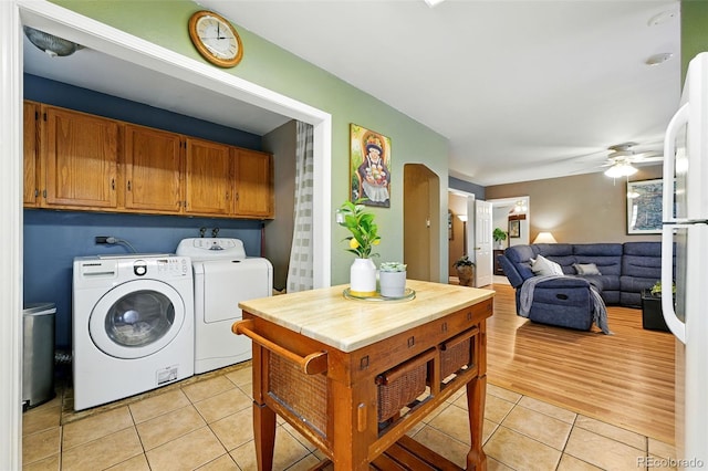 2461 Niagara St, Denver, CO 80207 - washroom with cabinet space, washer and dryer, light tile patterned flooring, and ceiling fan