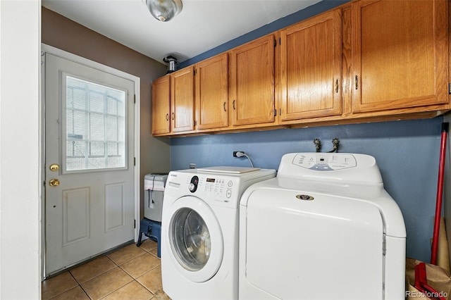 2461 Niagara St, Denver, CO 80207 - laundry room featuring washing machine and dryer, light tile patterned floors, and cabinet space