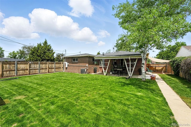 2461 Niagara St, Denver, CO 80207 - back of property featuring a fenced backyard, brick siding, and a patio area