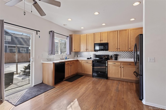 kitchen featuring black appliances, ceiling fan, light brown cabinetry, light hardwood / wood-style flooring, and backsplash