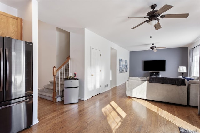 living room with ceiling fan and hardwood / wood-style flooring