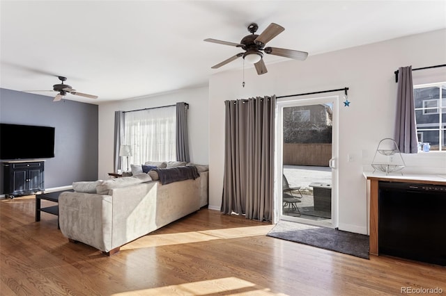 living room featuring light wood-type flooring and ceiling fan