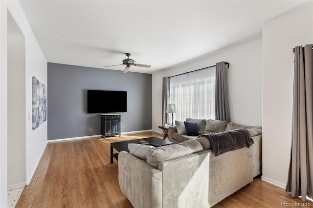 living room with ceiling fan and light hardwood / wood-style floors