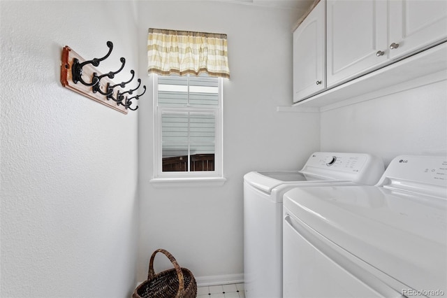 washroom featuring cabinets and washing machine and dryer