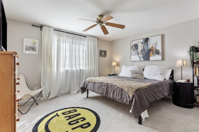 bedroom with ceiling fan and light colored carpet