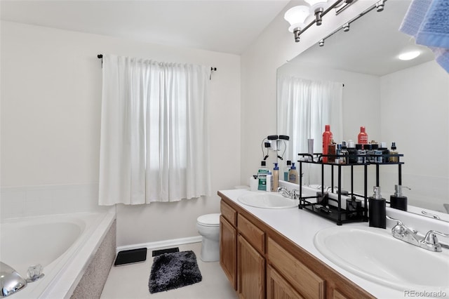 bathroom with toilet, a tub, tile patterned floors, and vanity