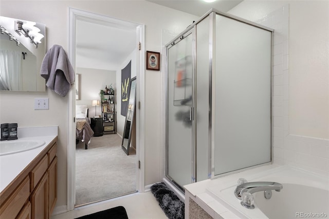 bathroom with separate shower and tub and vanity