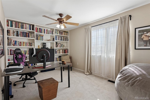 office space with ceiling fan and light carpet